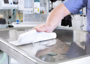 healthcare cleaner, cleaning stainless steel with recycled microfibre wipe